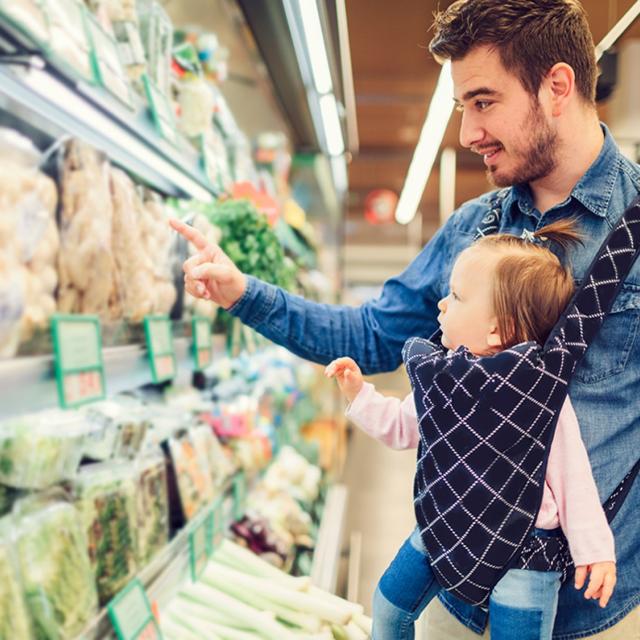 Father with baby shopping in a supermarket